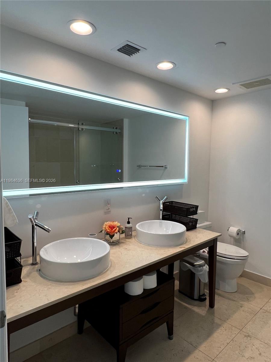 485 Brickell Avenue, Unit 4109 Miami, FL 33131 - Photo 12 of 15 a bathroom with a sink and a mirror