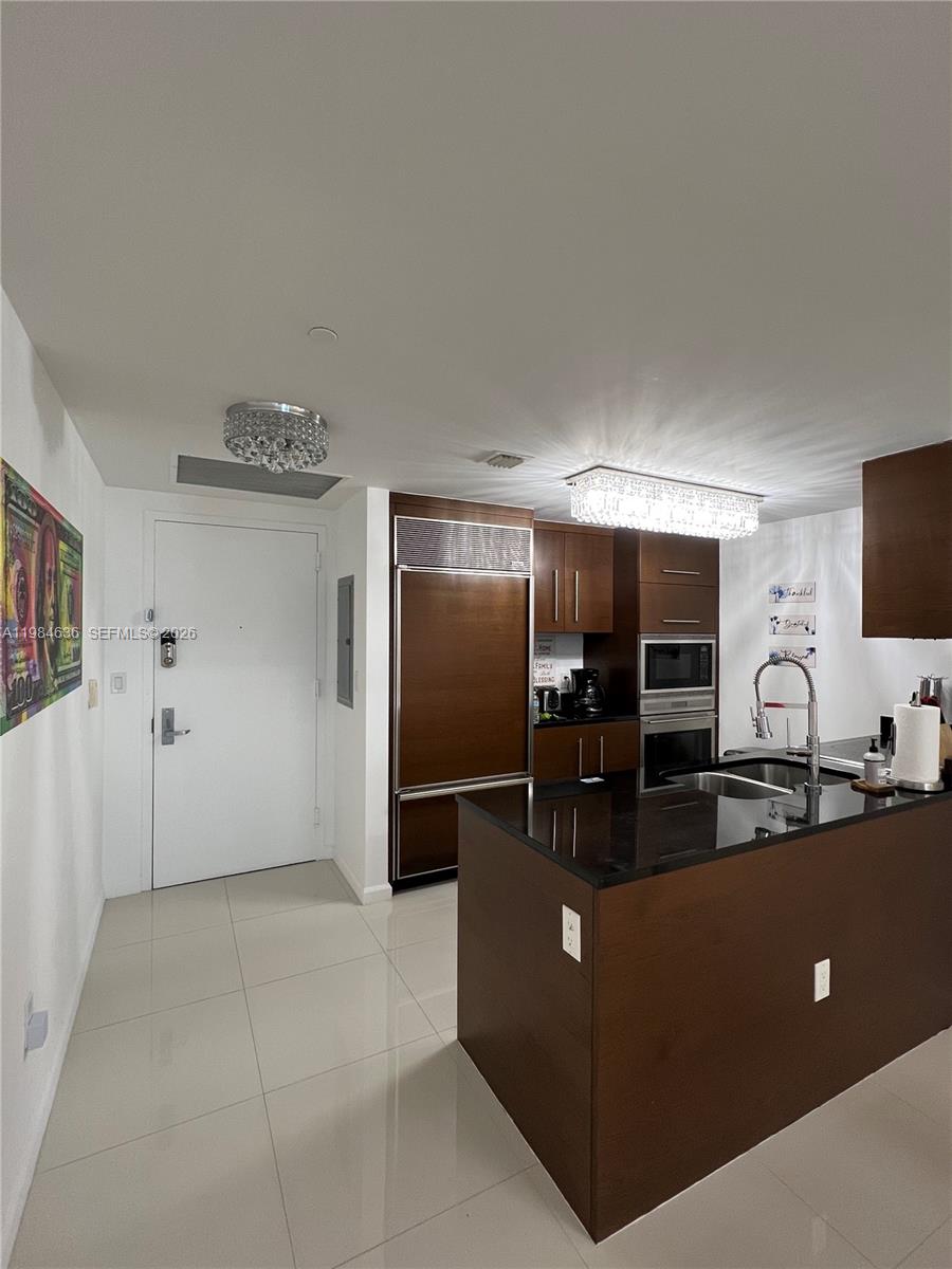 485 Brickell Avenue, Unit 4109 Miami, FL 33131 - Photo 4 of 15 a living room with furniture and a flat screen tv