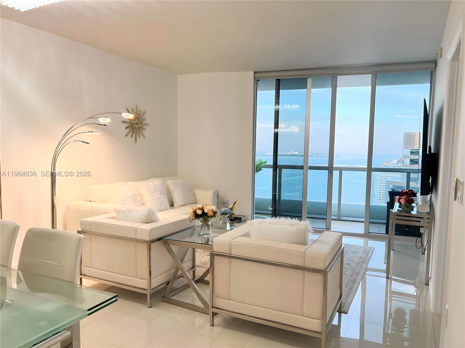 485 Brickell Avenue, Unit 4109 Miami, FL 33131 - Photo 5 of 15 a living room with furniture and a floor to ceiling window