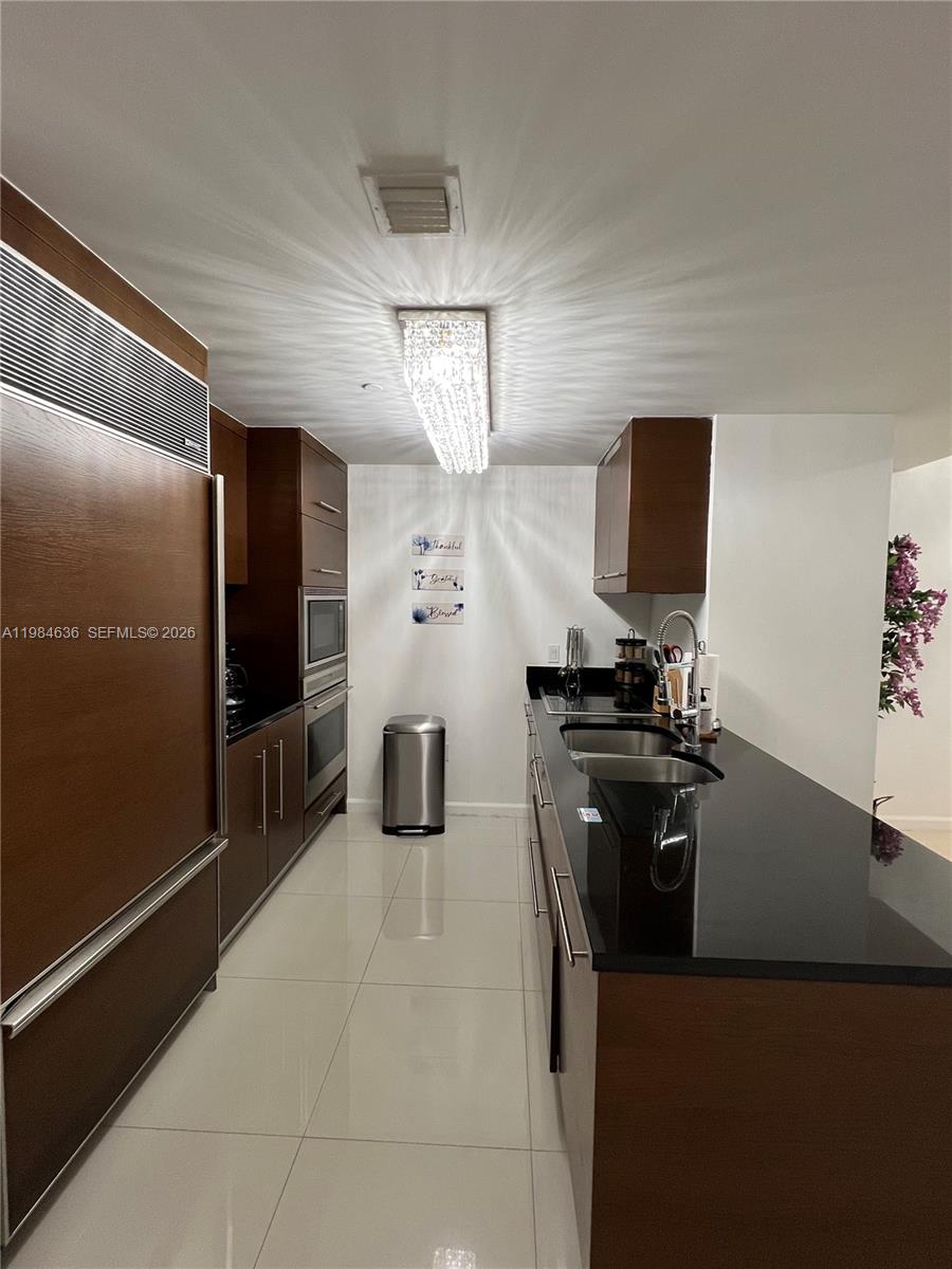 485 Brickell Avenue, Unit 4109 Miami, FL 33131 - Photo 7 of 15 a kitchen with a refrigerator and a stove top oven