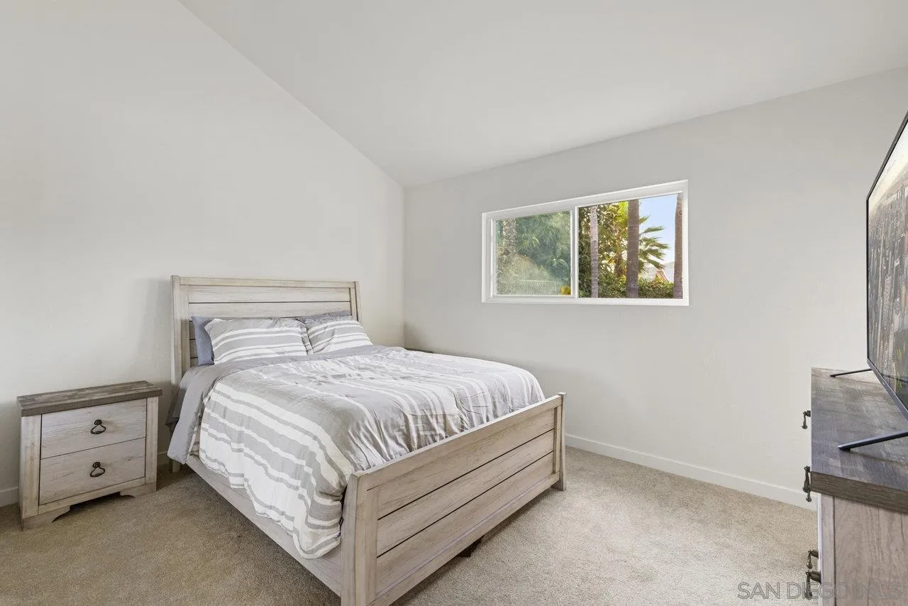 1066 Fulton Road San Marcos, CA 92069 - Photo 17 of 36 a bed sitting in a bedroom next to a window