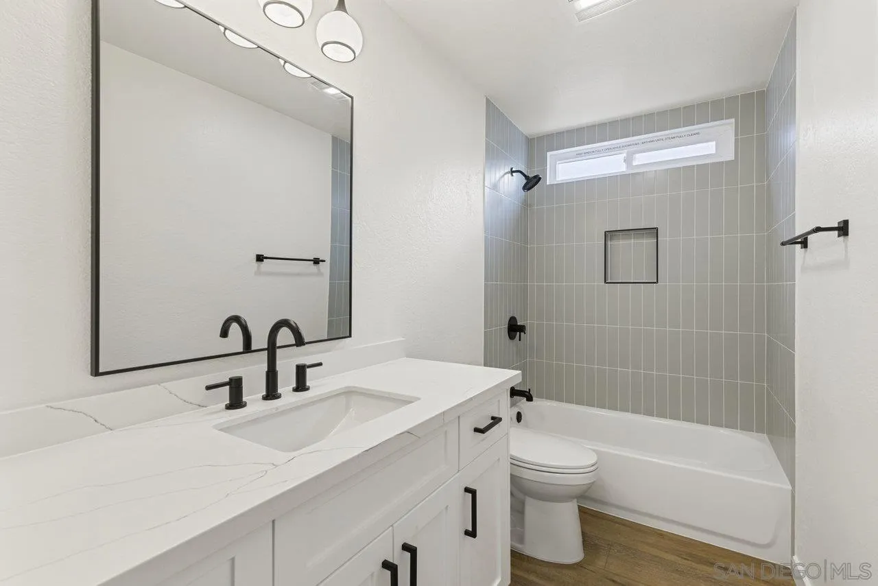 1066 Fulton Road San Marcos, CA 92069 - Photo 20 of 36 a bathroom with a sink a toilet and shower