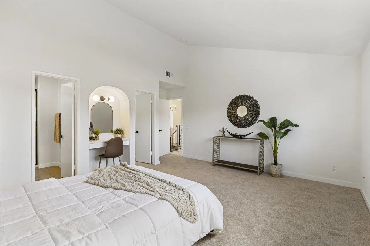 1066 Fulton Road San Marcos, CA 92069 - Photo 24 of 36 a bedroom with a bed and a chandelier