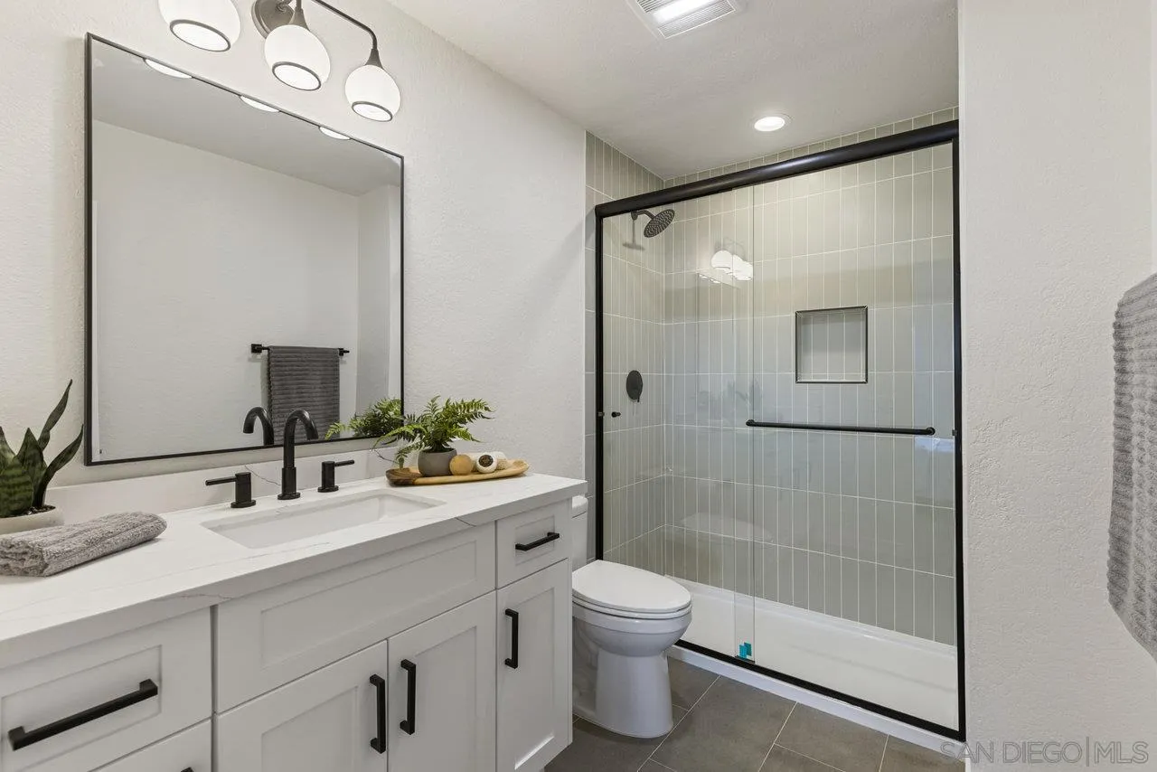1066 Fulton Road San Marcos, CA 92069 - Photo 3 of 36 a bathroom with a toilet sink and shower