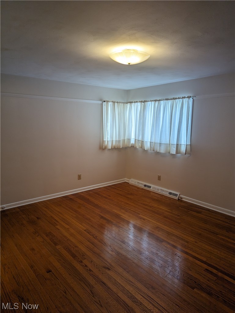 276 Paradise Road Painesville, OH 44077 - Photo 23 of 31 Spare room featuring dark wood-type flooring