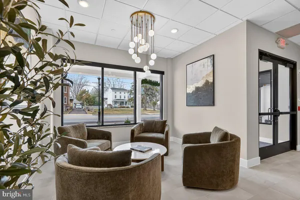a living room with furniture and a chandelier