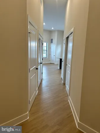 a view of a hallway with wooden floor
