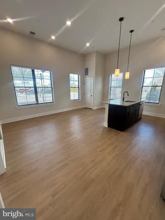 a view of a room with window and wooden floor
