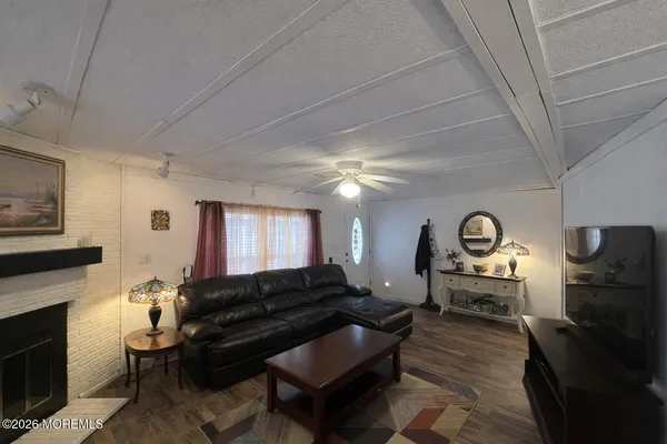 a living room with furniture a window and a fireplace