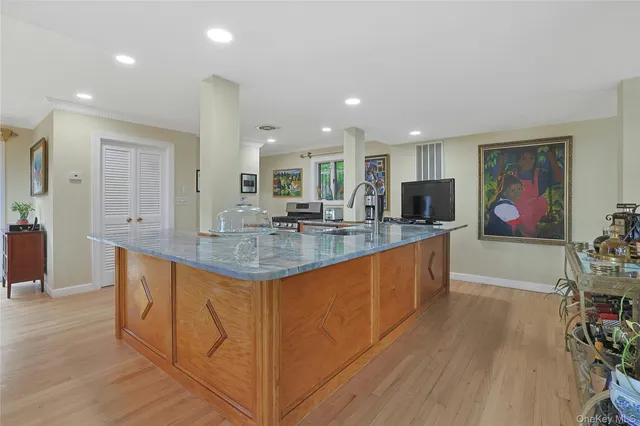 a view of kitchen with stainless steel appliances granite countertop sink and wooden floor