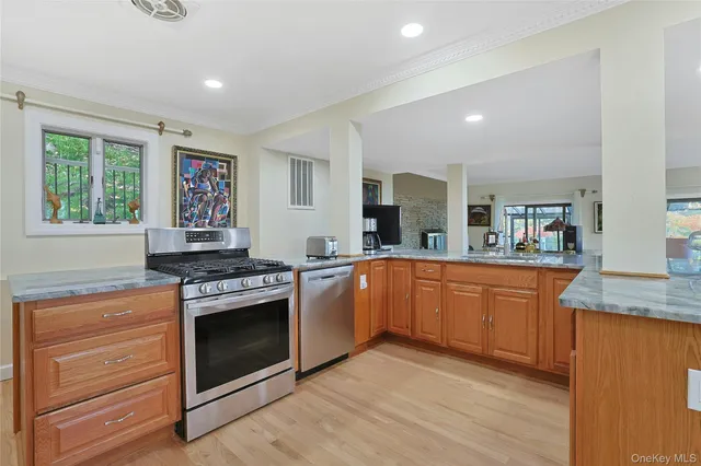 a kitchen with stainless steel appliances granite countertop a stove and a sink