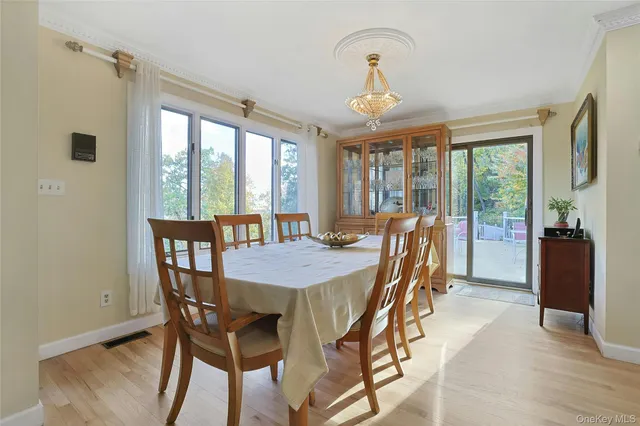 a view of a dining room with furniture large windows and wooden floor