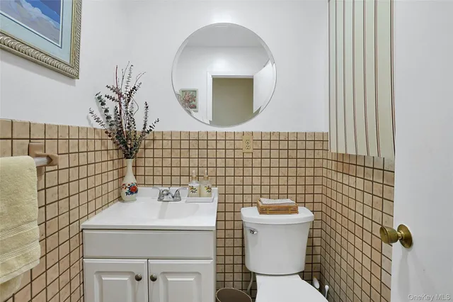 a bathroom with a sink toilet and a mirror