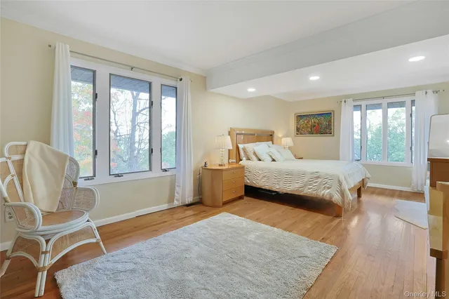 a bedroom with a bed chair and window