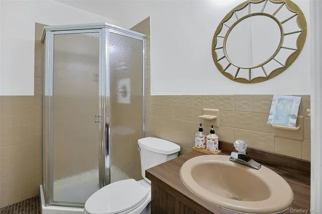 a bathroom with a sink a toilet and a mirror