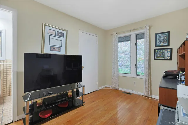 a living room with window and a flat screen tv
