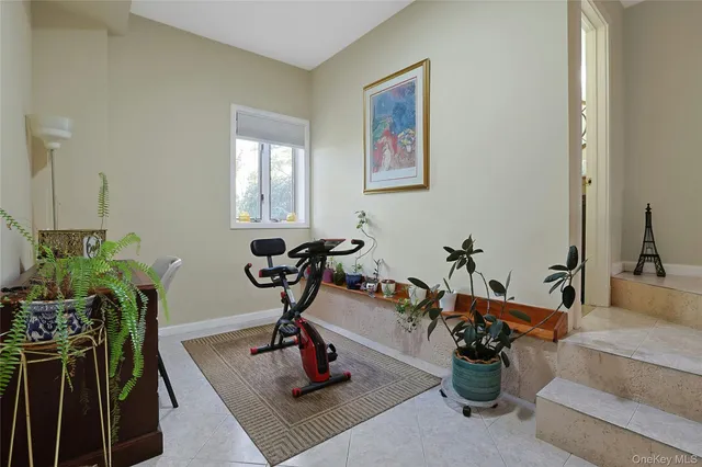 a view of a livingroom with furniture and a potted plant