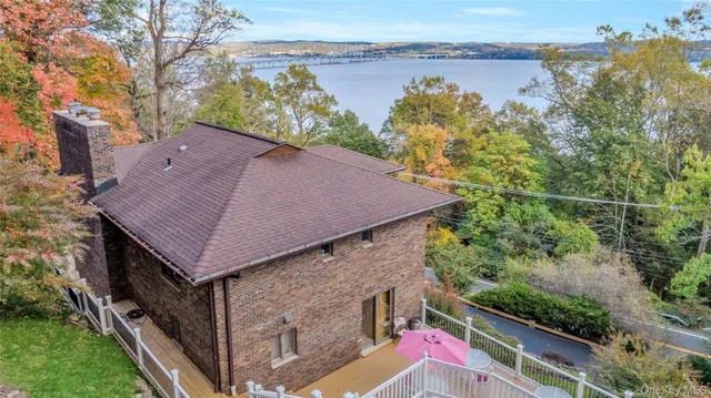 a aerial view of a house with a yard and sitting area