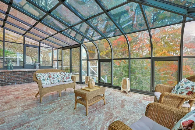 a living room with furniture and a floor to ceiling window