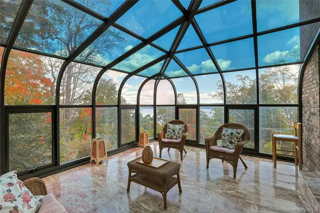 a living room with furniture and floor to ceiling windows