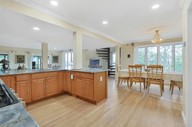a large kitchen with cabinets table and chairs