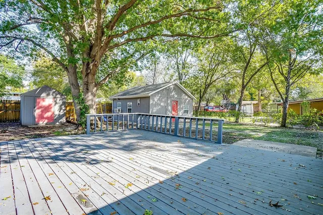 a view of a porch with wooden floor and fence