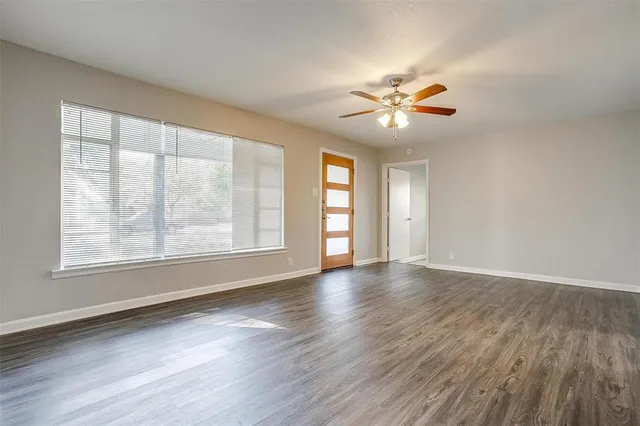 wooden floor in an empty room with a window