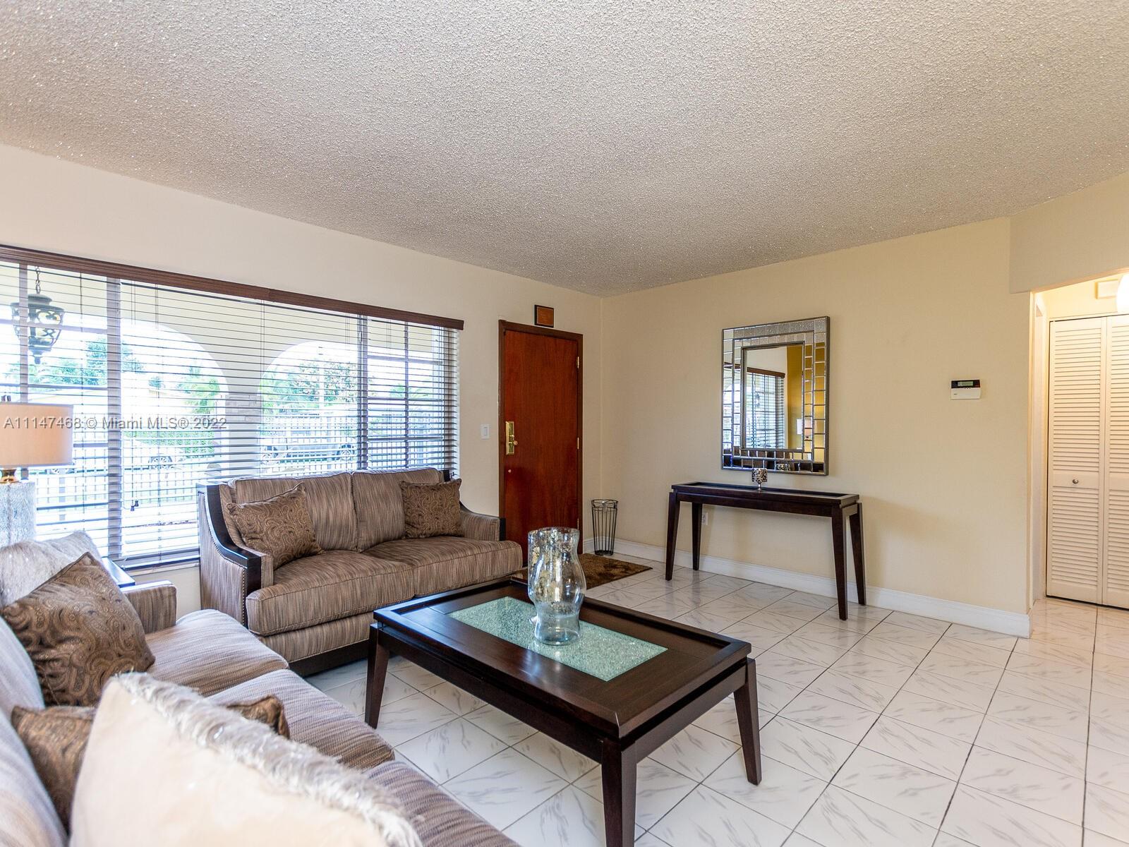 490 West 33rd Place Hialeah, FL 33012 - Photo 11 of 88 a living room with furniture and a window