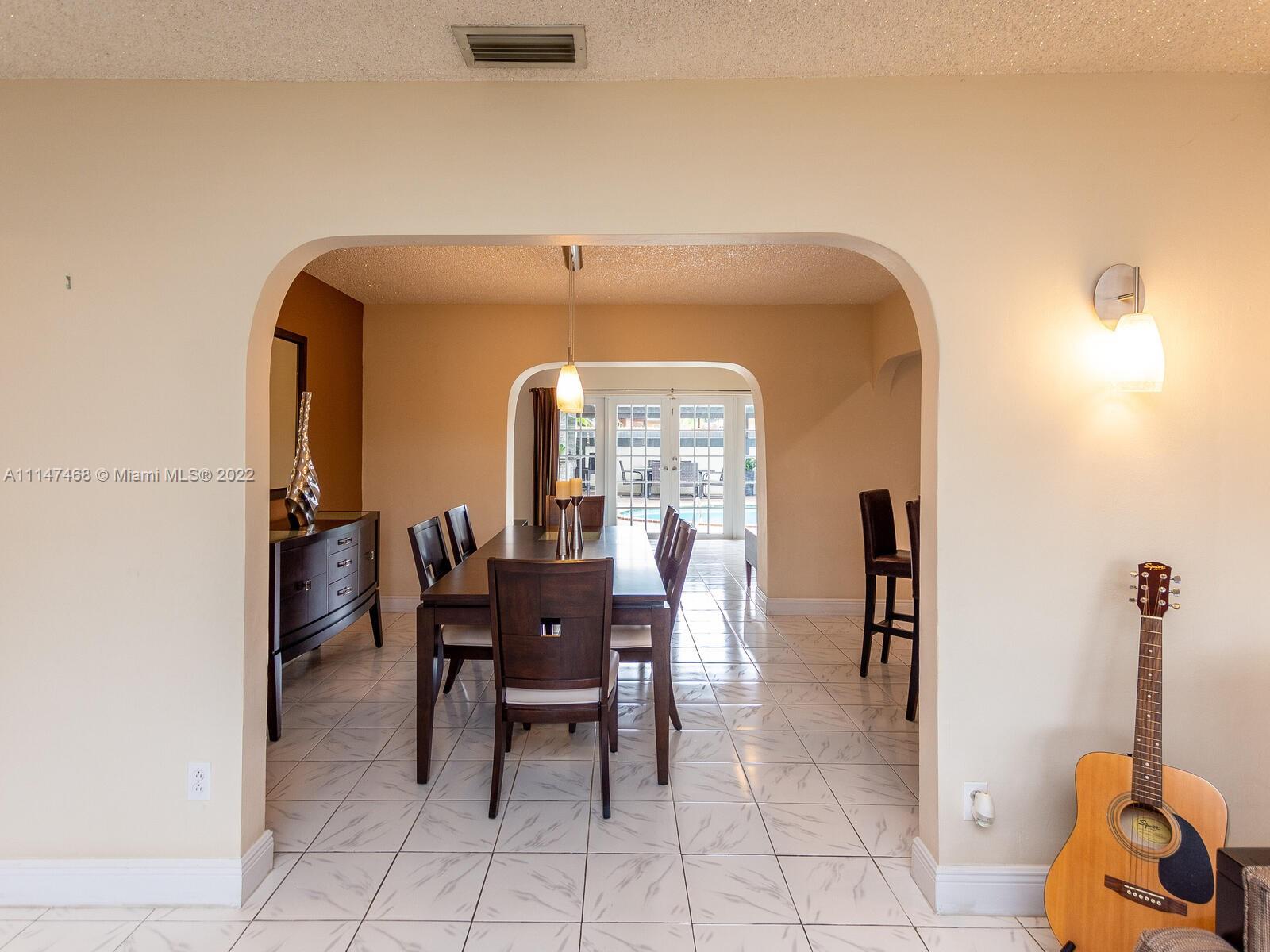 490 West 33rd Place Hialeah, FL 33012 - Photo 15 of 88 a view of a dining room with furniture and a potted plant