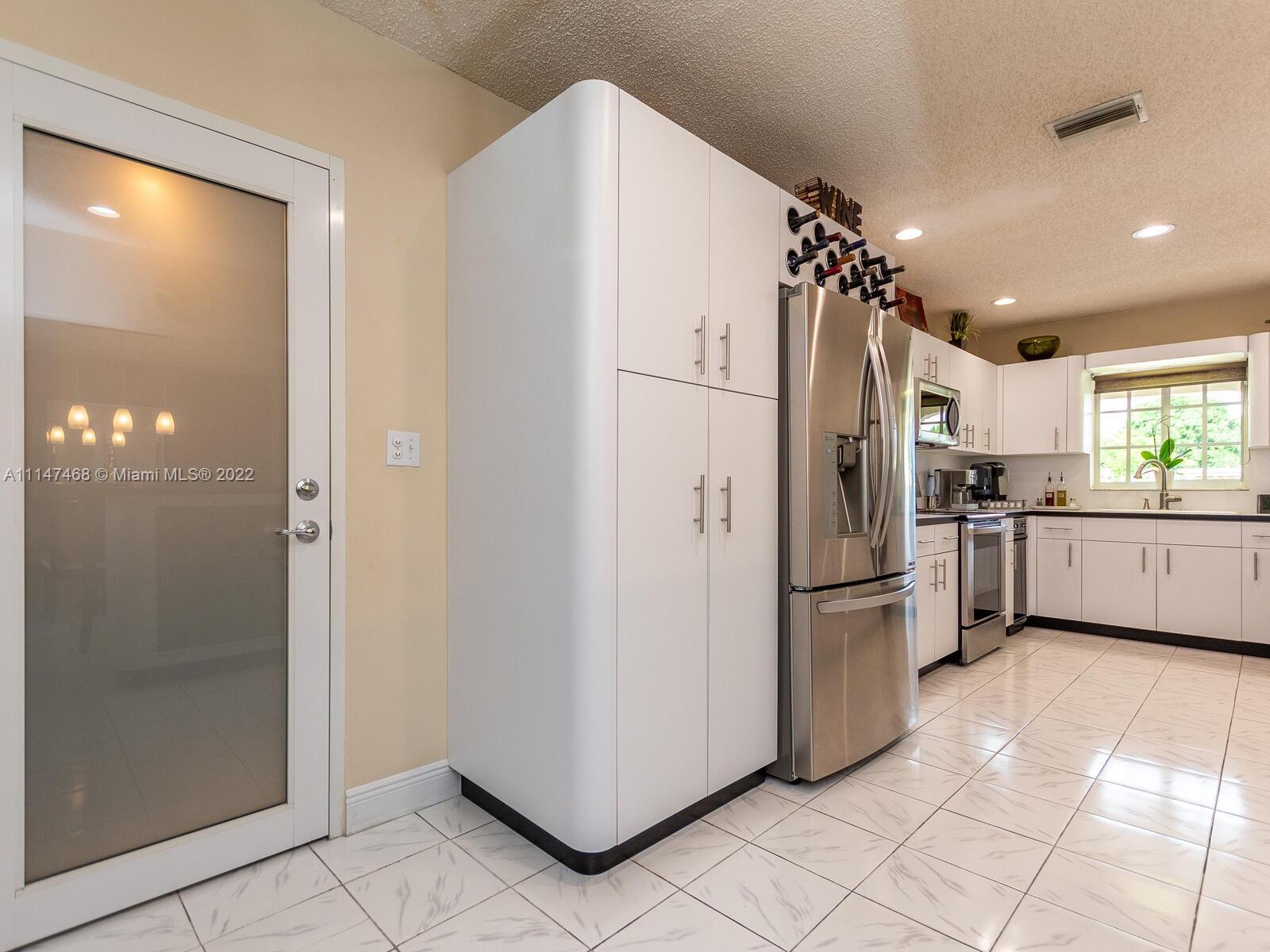 490 West 33rd Place Hialeah, FL 33012 - Photo 24 of 88 a kitchen with stainless steel appliances a refrigerator and a sink