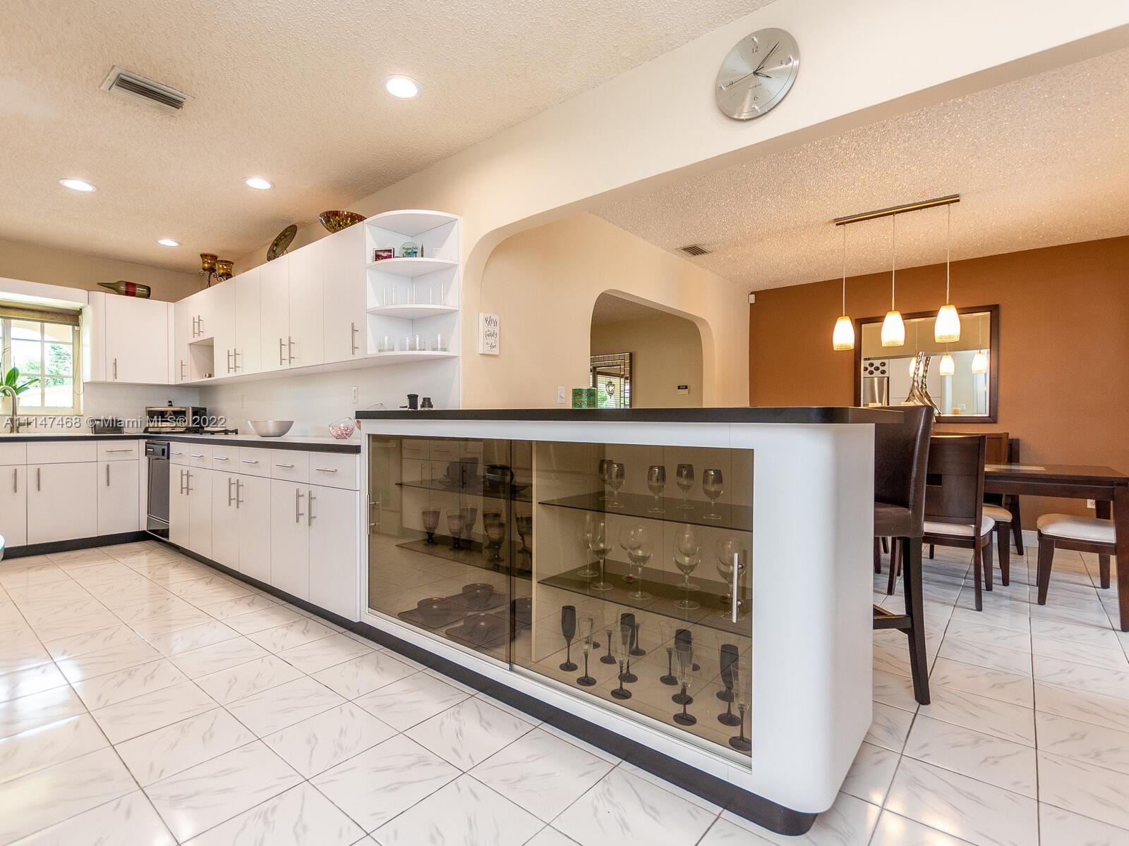 490 West 33rd Place Hialeah, FL 33012 - Photo 25 of 88 a kitchen with stainless steel appliances granite countertop a stove a sink and a refrigerator