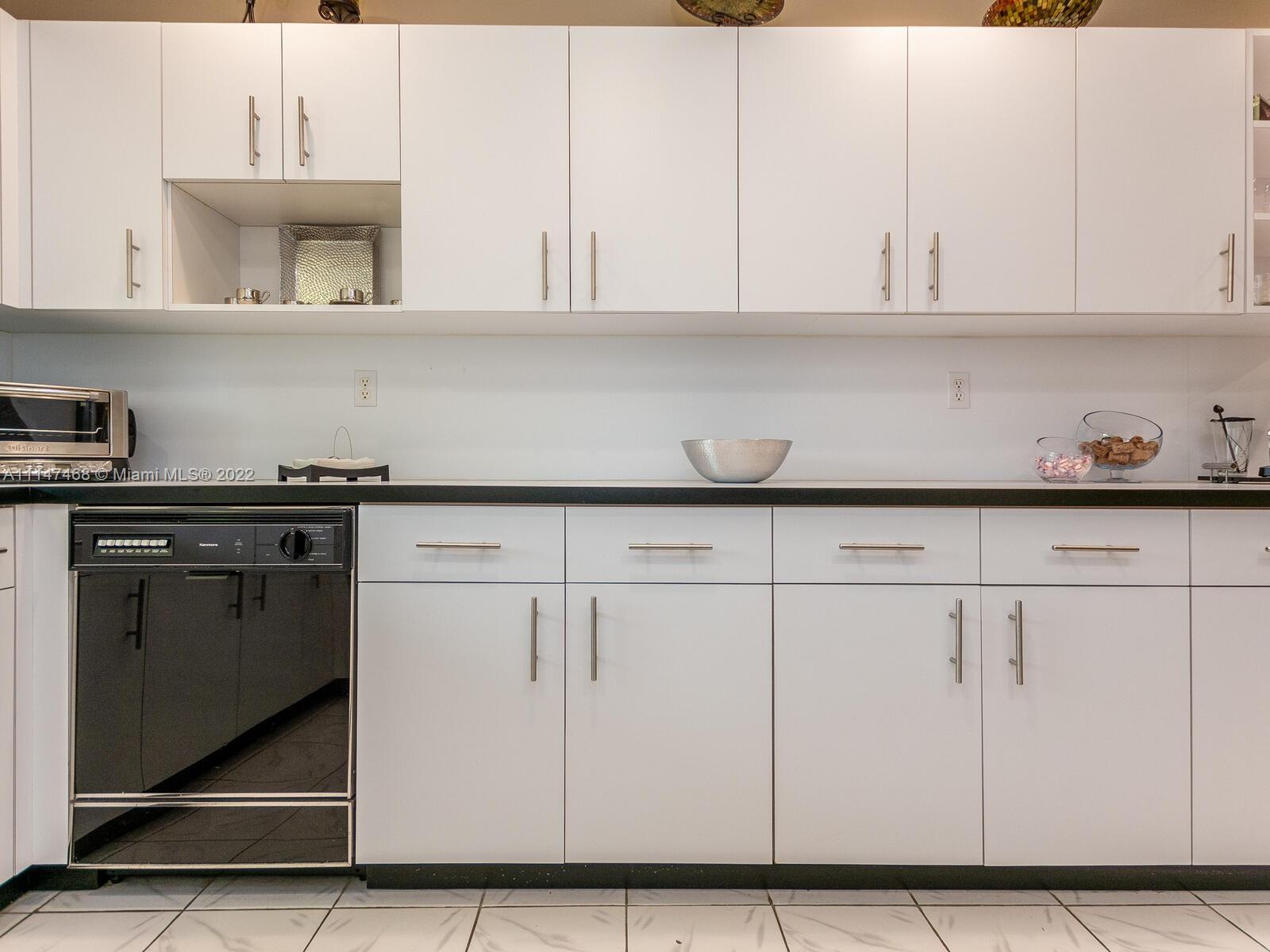 490 West 33rd Place Hialeah, FL 33012 - Photo 28 of 88 a kitchen with white cabinets and sink