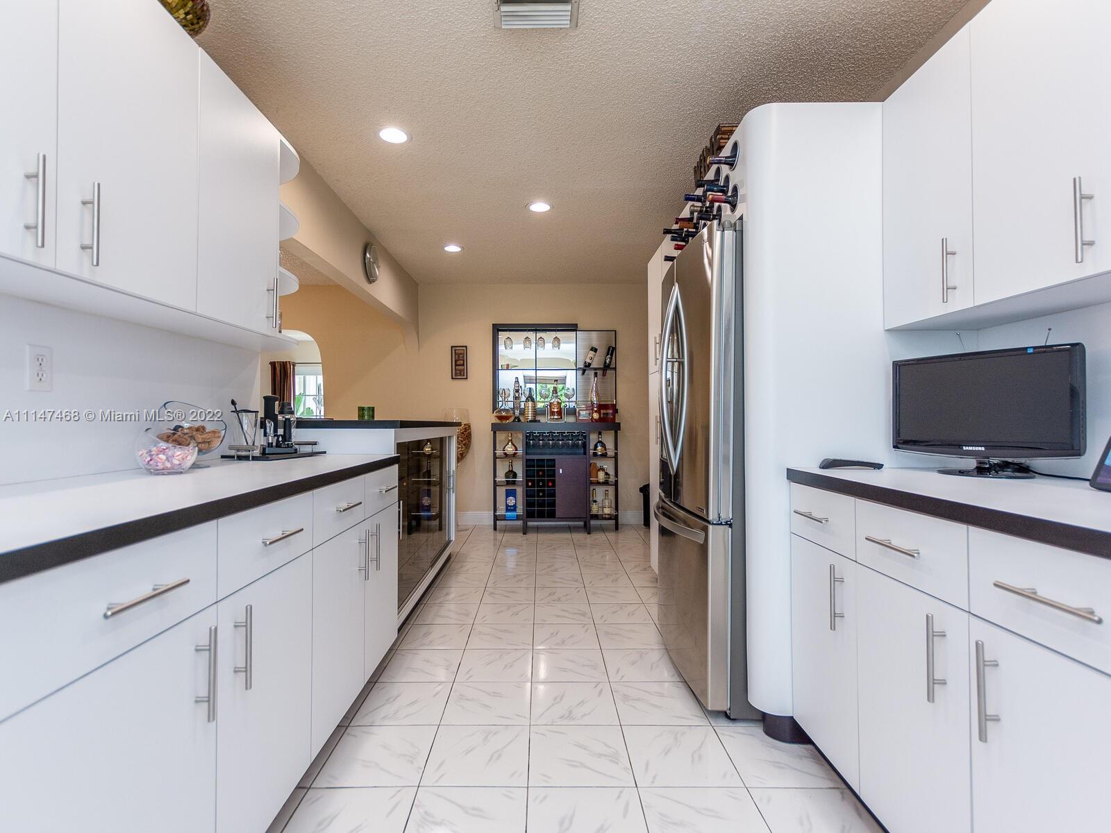 490 West 33rd Place Hialeah, FL 33012 - Photo 29 of 88 a kitchen with a sink and refrigerator
