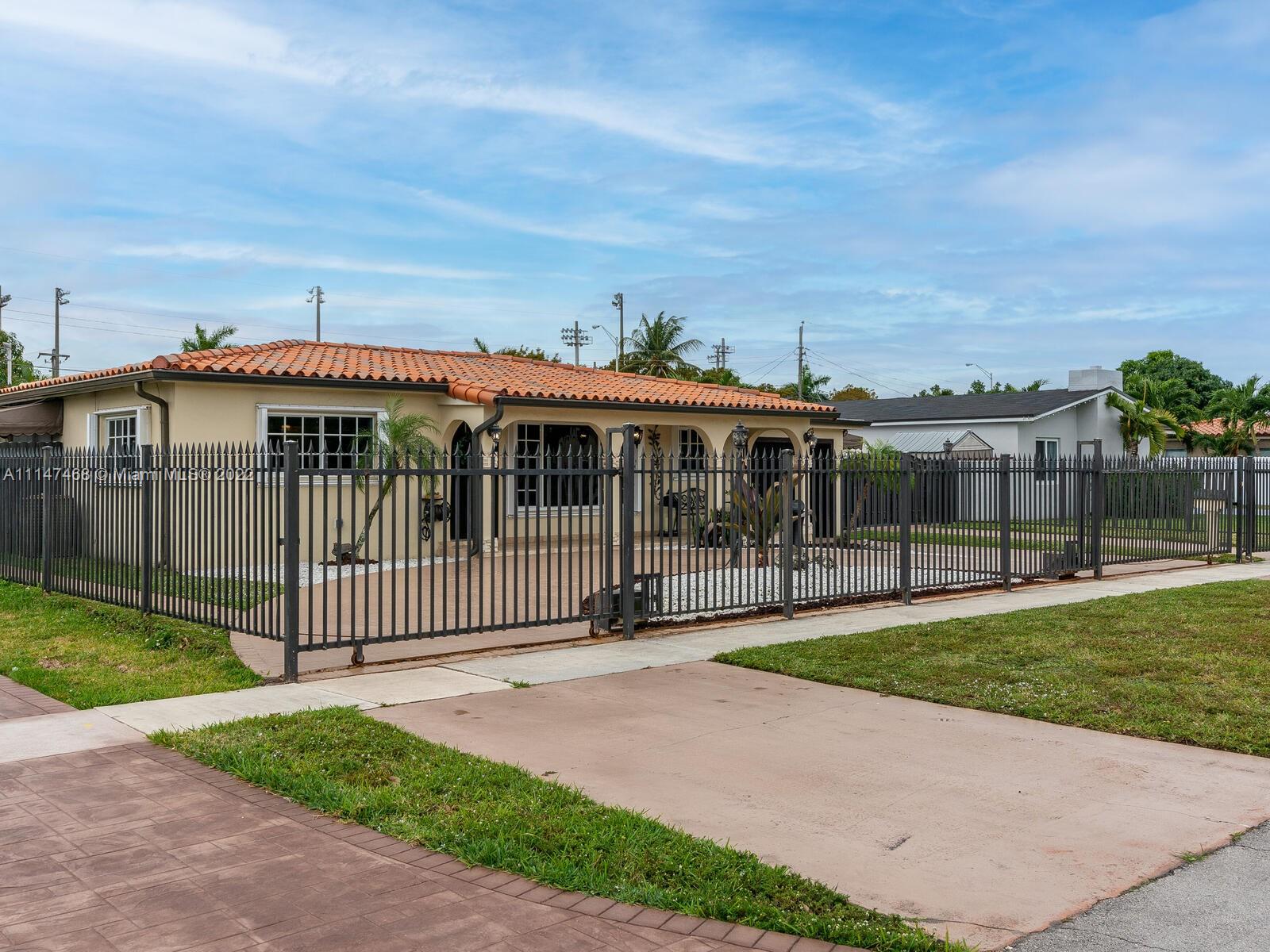 490 West 33rd Place Hialeah, FL 33012 - Photo 3 of 88 a front view of a house with a garden and pathway