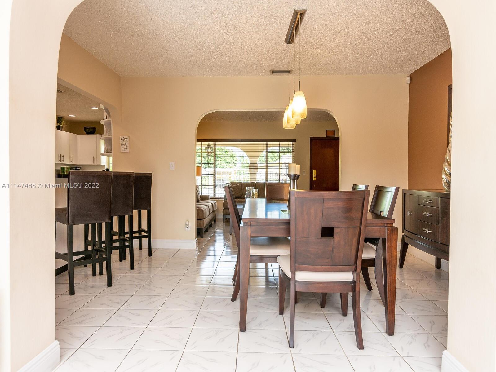 490 West 33rd Place Hialeah, FL 33012 - Photo 32 of 88 a dining room with furniture window and wooden floor