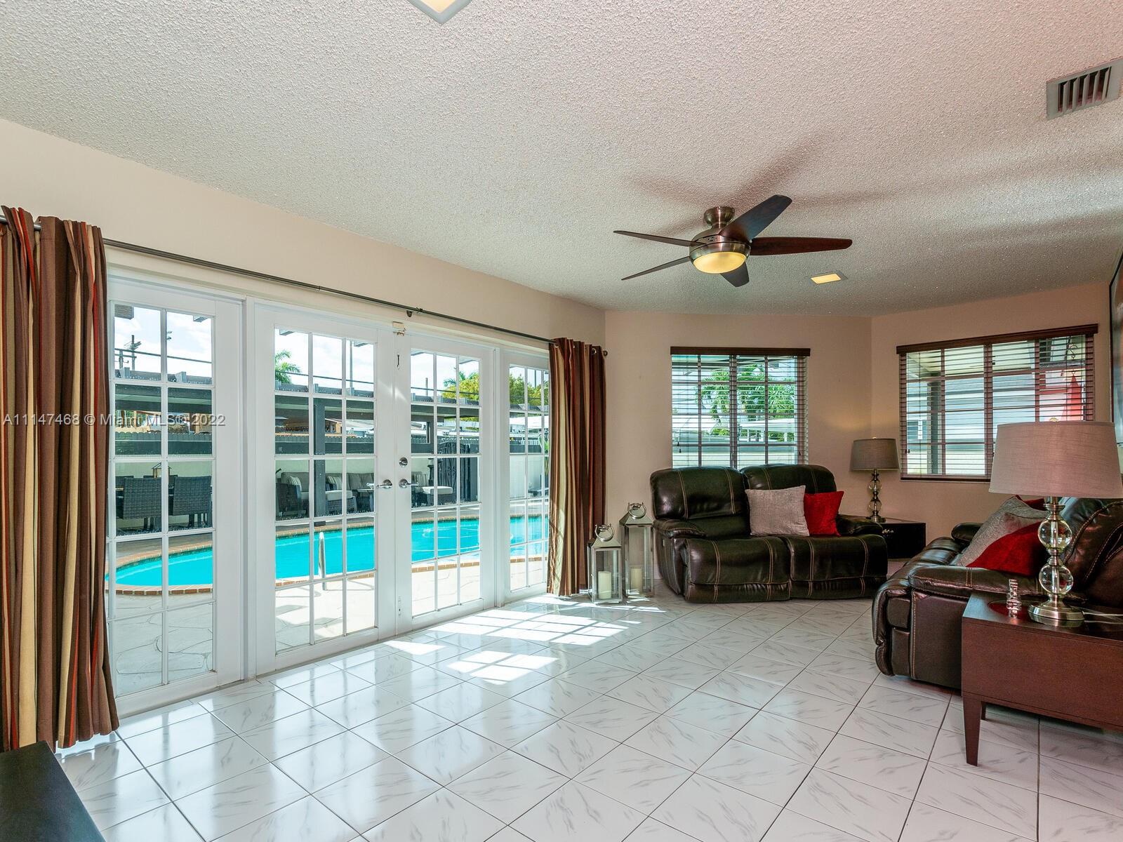 490 West 33rd Place Hialeah, FL 33012 - Photo 33 of 88 a living room with furniture and a large window