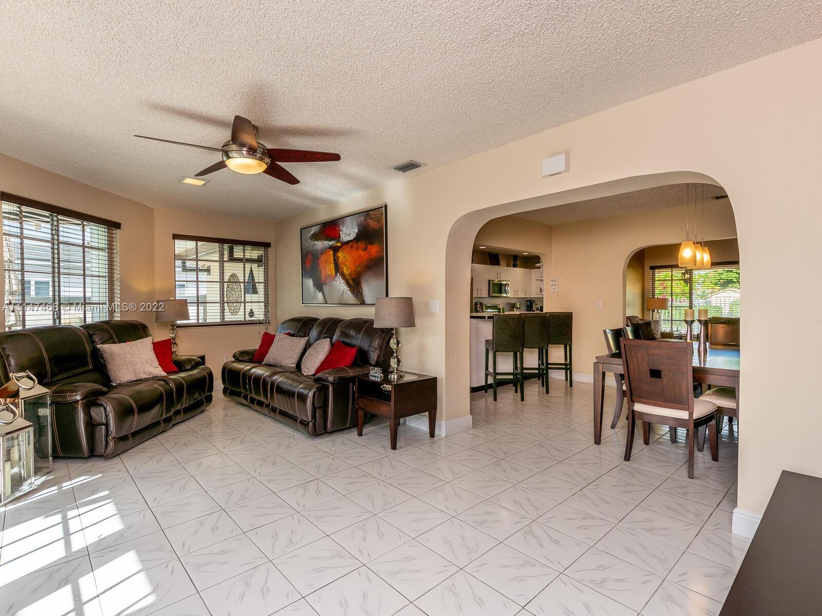 490 West 33rd Place Hialeah, FL 33012 - Photo 35 of 88 a living room with furniture and a flat screen tv