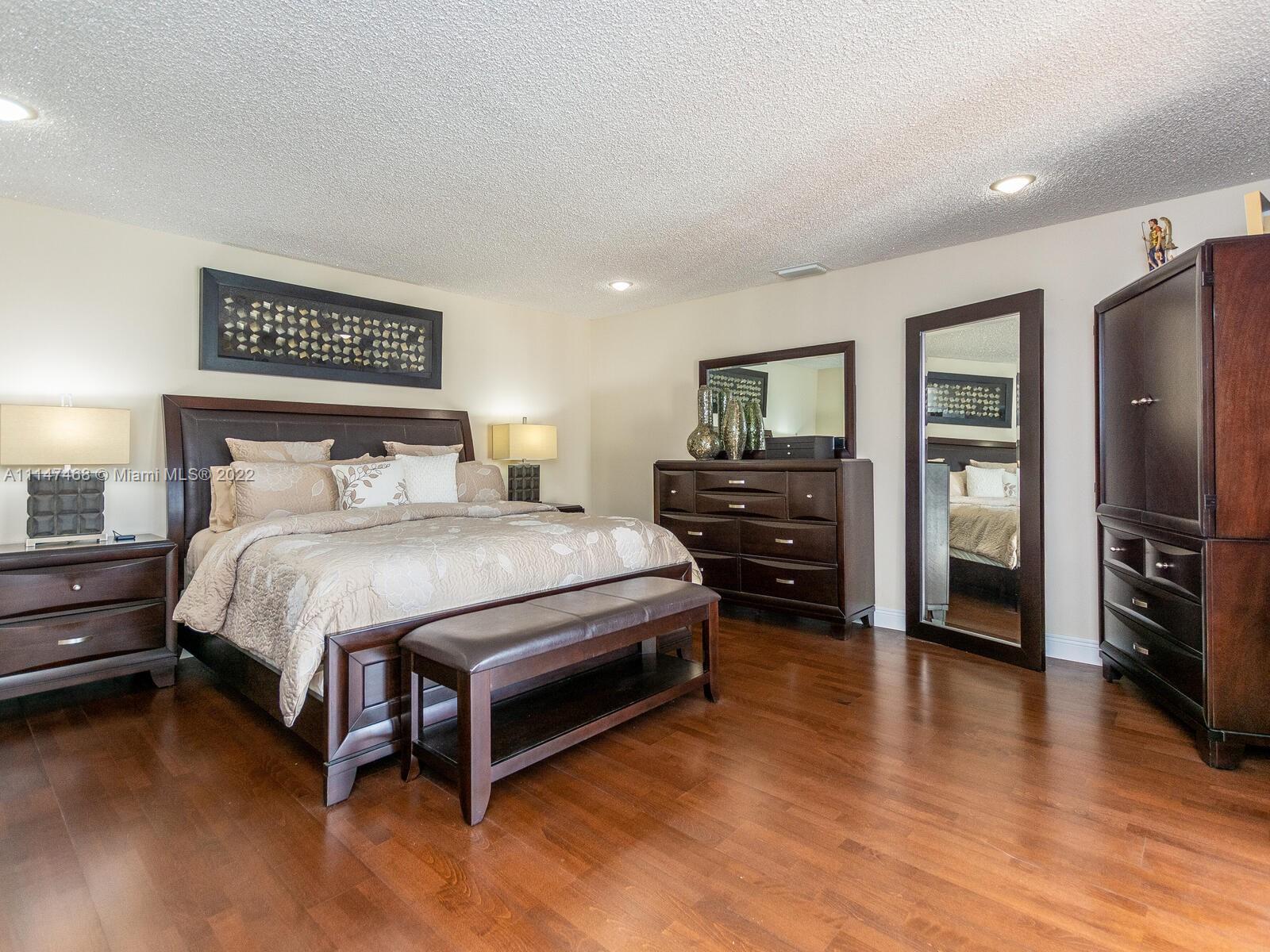 490 West 33rd Place Hialeah, FL 33012 - Photo 39 of 88 a spacious bedroom with a bed and a flat screen tv