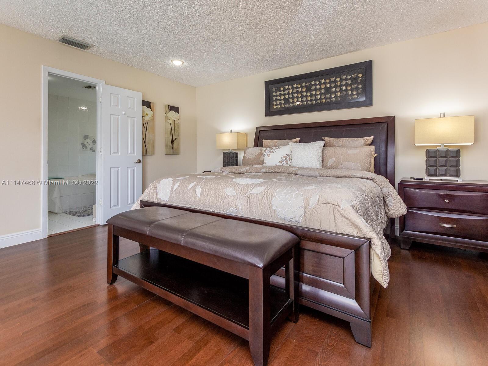 490 West 33rd Place Hialeah, FL 33012 - Photo 40 of 88 a bedroom with a bed and a night stand