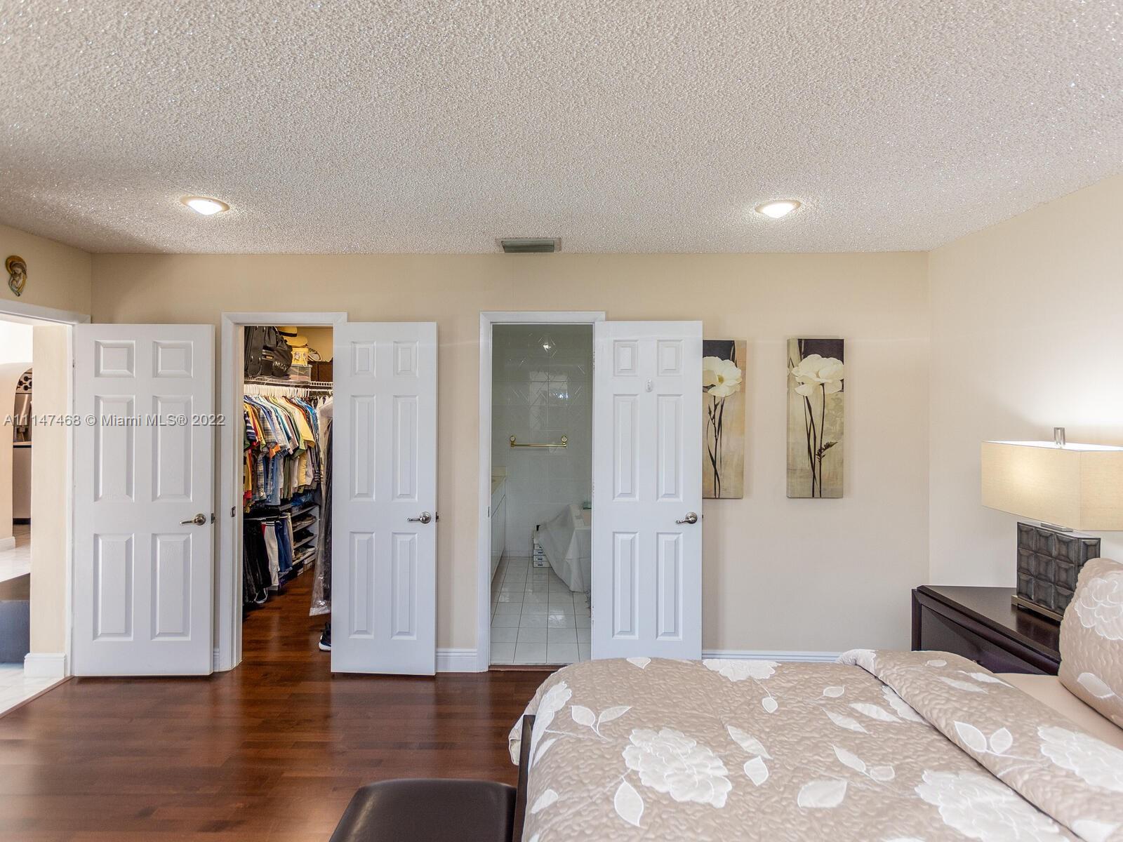 490 West 33rd Place Hialeah, FL 33012 - Photo 43 of 88 a bedroom with a bed and a lamp