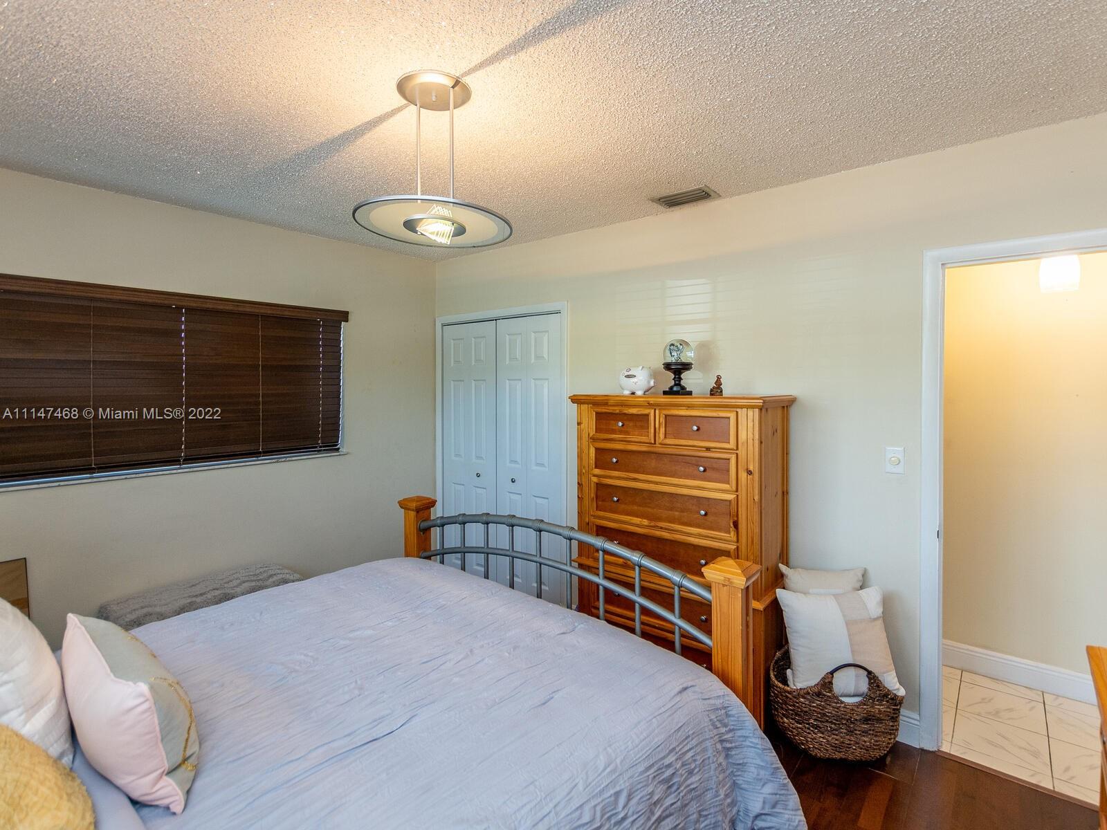 490 West 33rd Place Hialeah, FL 33012 - Photo 51 of 88 a bedroom with a bed and a tv