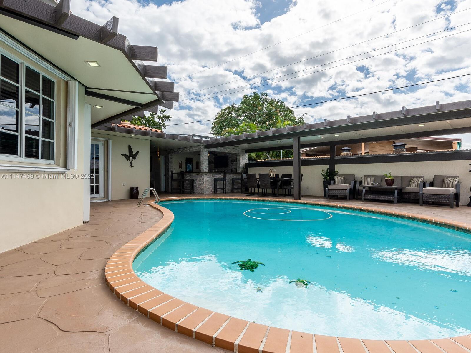 490 West 33rd Place Hialeah, FL 33012 - Photo 58 of 88 a view of a patio with swimming pool table and chairs