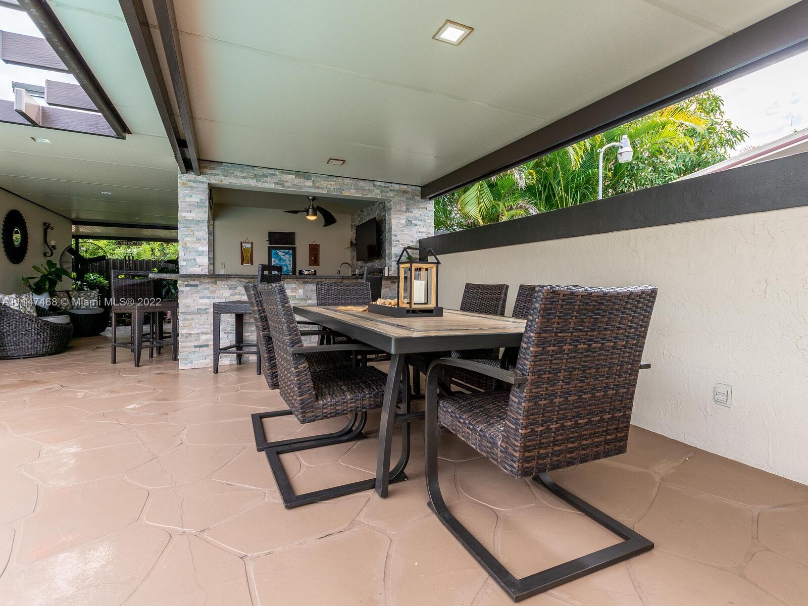490 West 33rd Place Hialeah, FL 33012 - Photo 63 of 88 a dining room with furniture and a floor to ceiling window