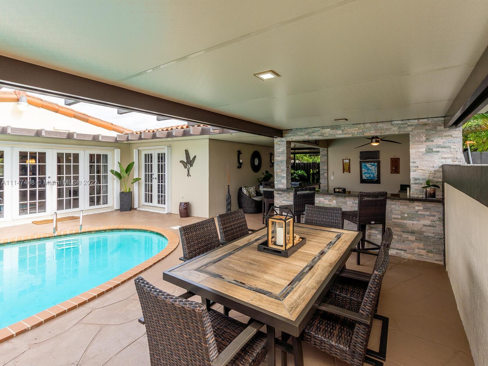 490 West 33rd Place Hialeah, FL 33012 - Photo 64 of 88 a dinning table and chairs in patio of a house