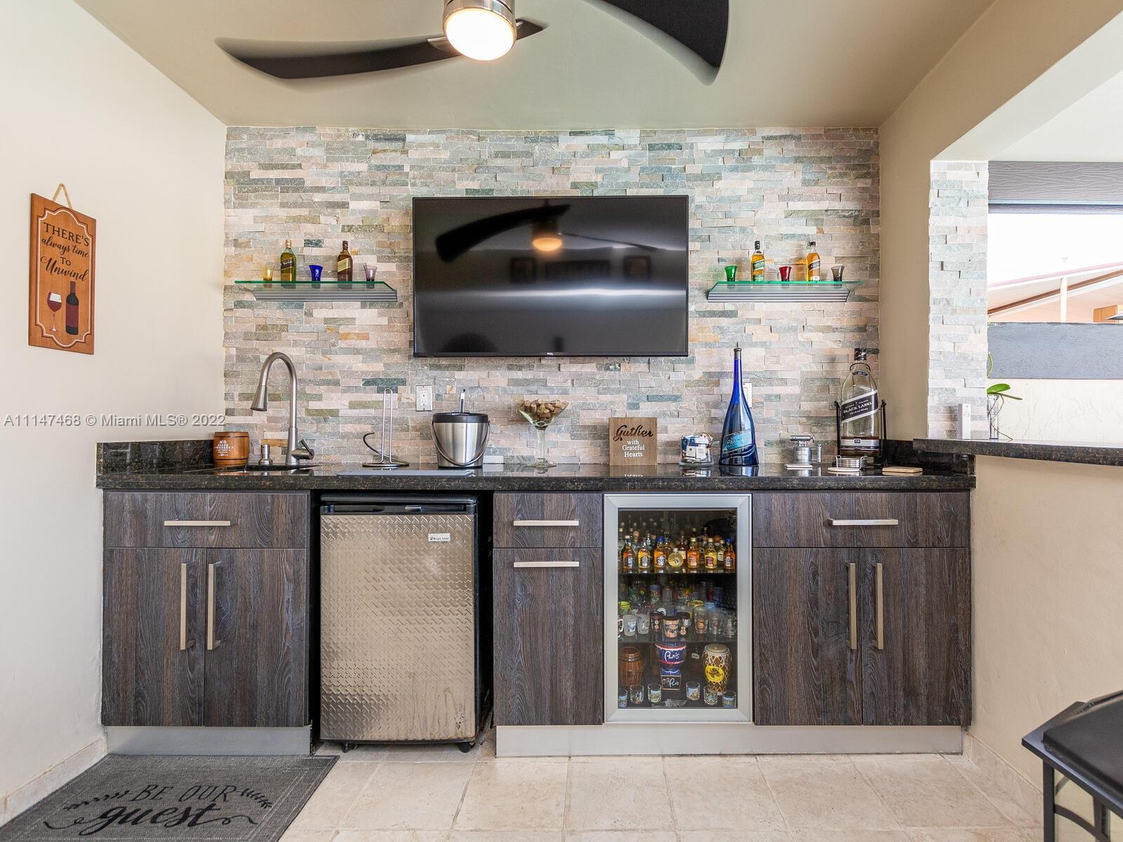 490 West 33rd Place Hialeah, FL 33012 - Photo 67 of 88 a kitchen with granite countertop a stove and a wooden floor