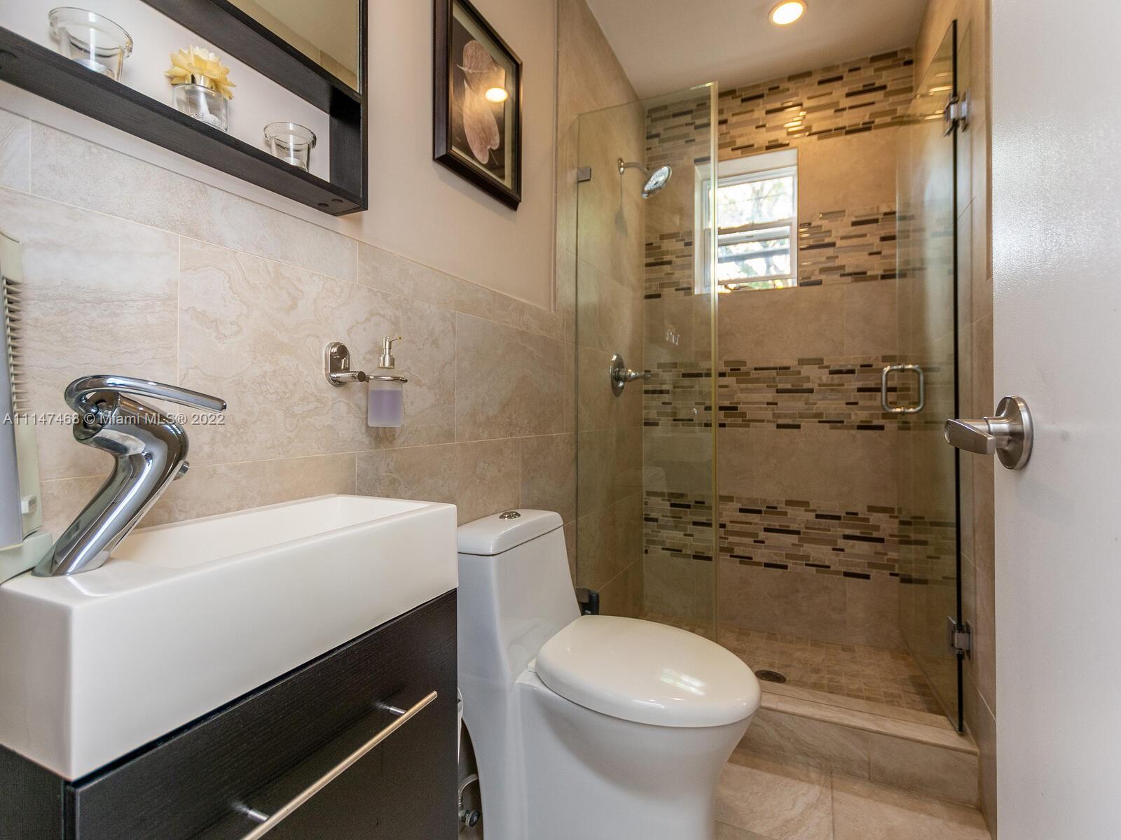 490 West 33rd Place Hialeah, FL 33012 - Photo 73 of 88 a bathroom with a sink a toilet and shower