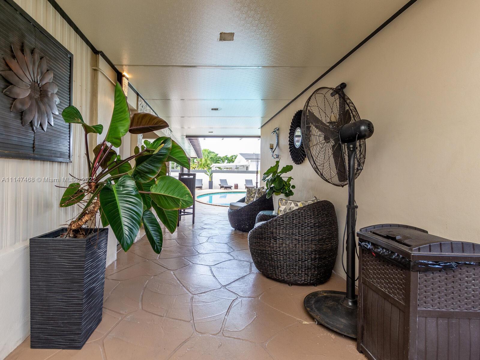 490 West 33rd Place Hialeah, FL 33012 - Photo 76 of 88 a living room with furniture and a potted plant
