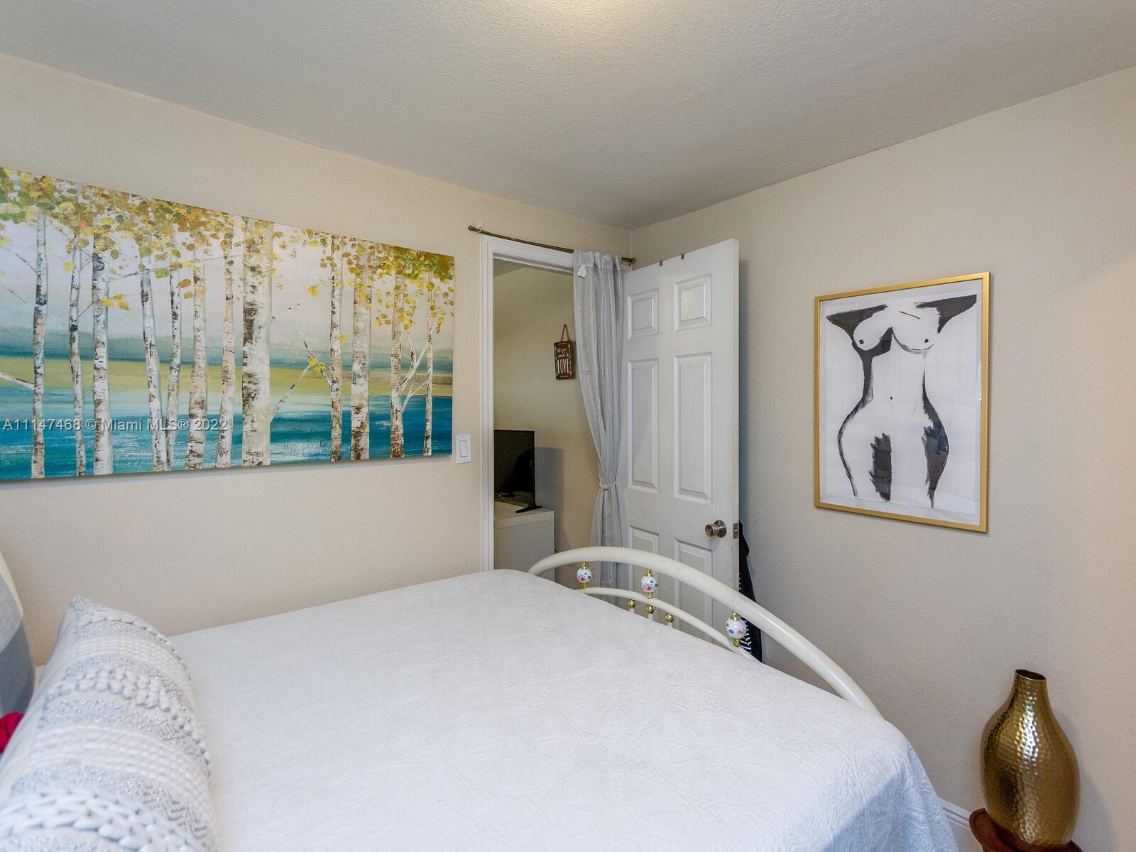 490 West 33rd Place Hialeah, FL 33012 - Photo 86 of 88 a bedroom with a large bed and a window