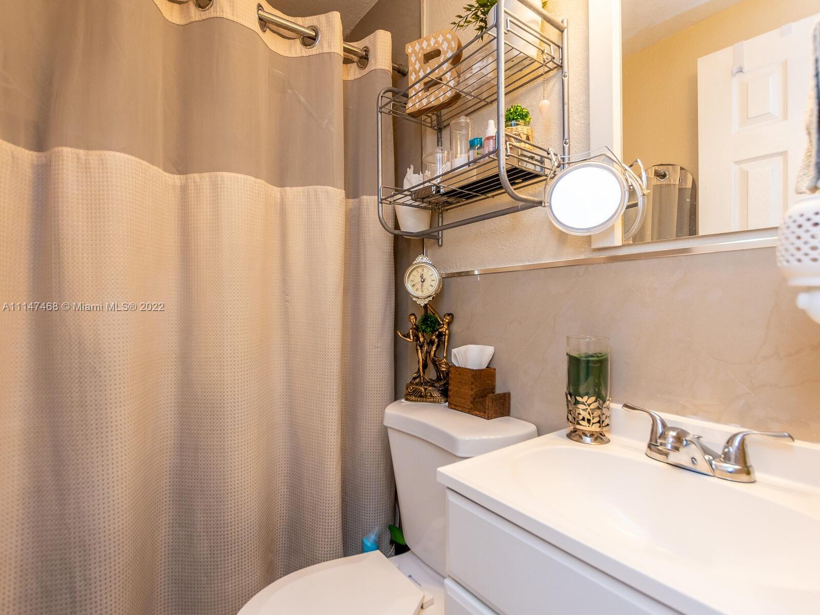 490 West 33rd Place Hialeah, FL 33012 - Photo 88 of 88 a bathroom with a sink vanity mirror and toilet