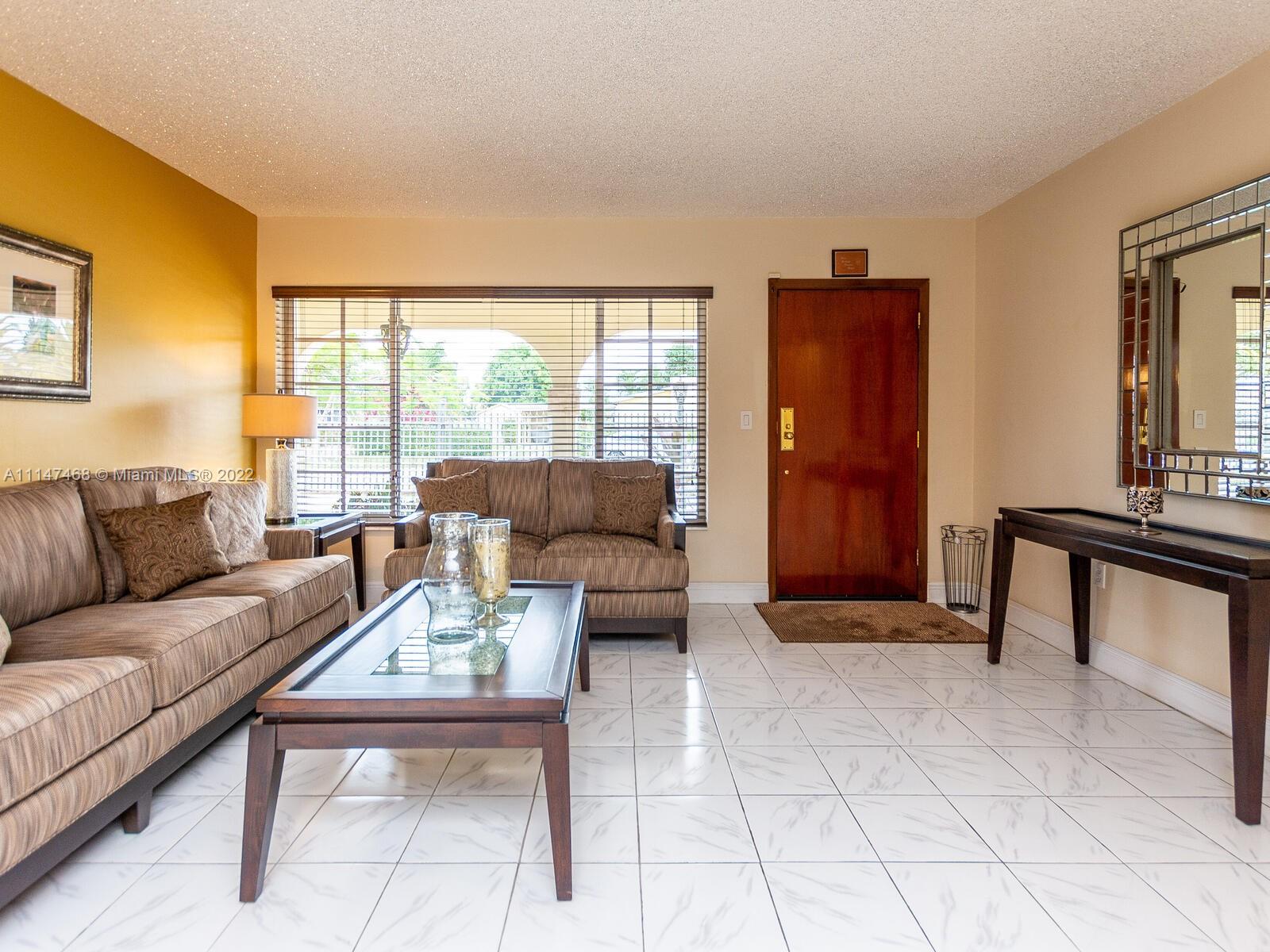 490 West 33rd Place Hialeah, FL 33012 - Photo 9 of 88 a living room with furniture and a window